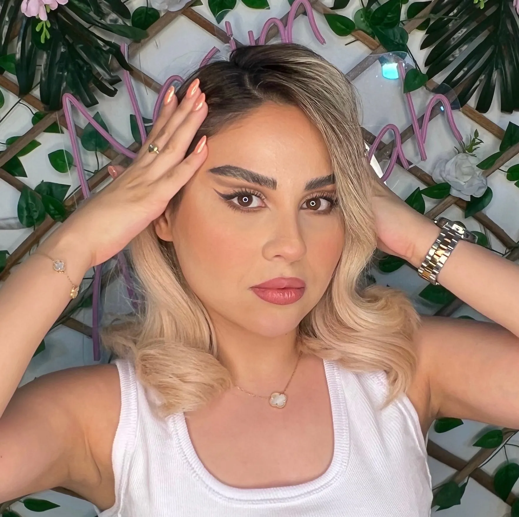 Glam look with winged eyeliner, sculpted brows and a mauve lip