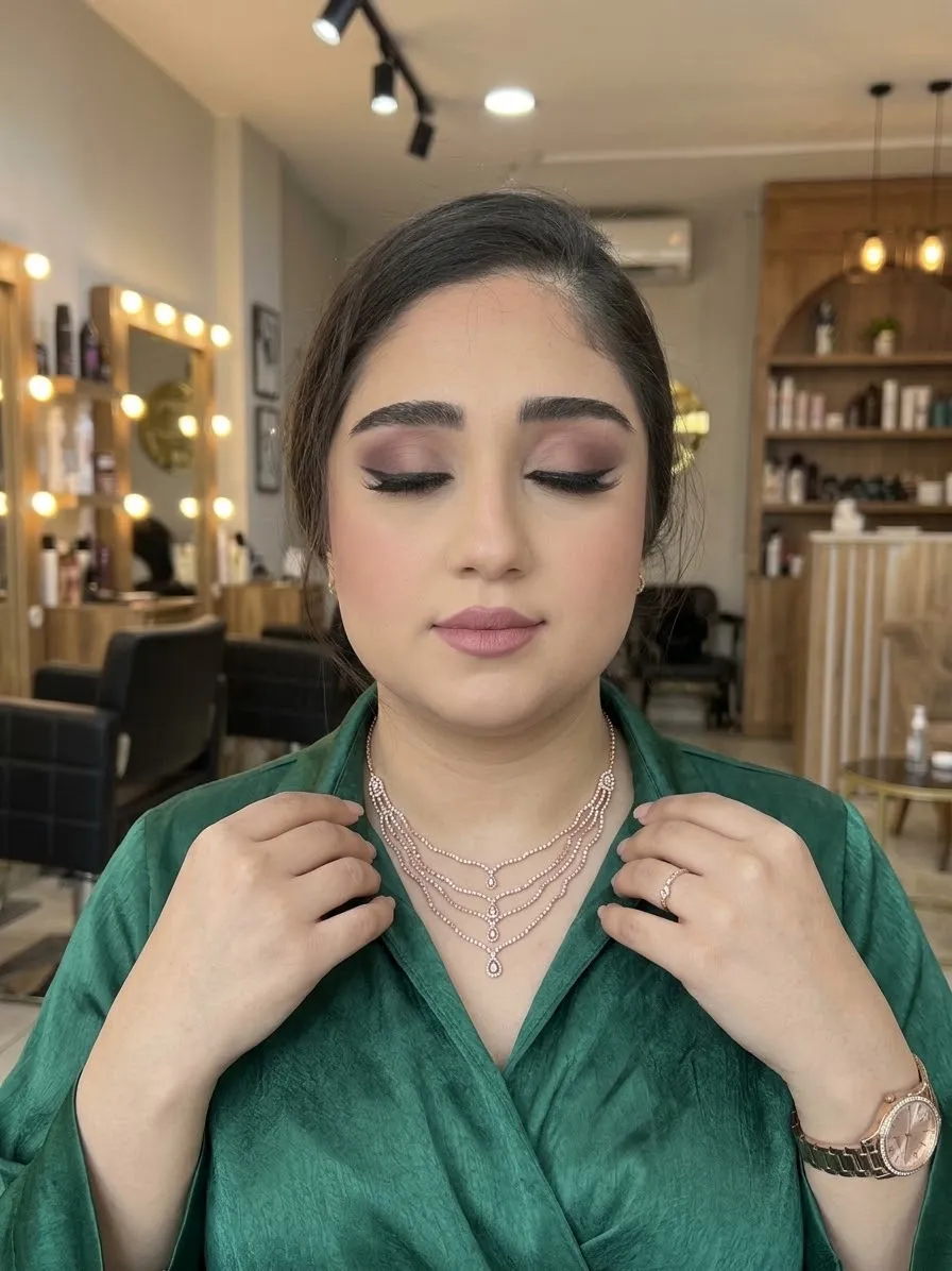 Mauve smoky eyes with defined lashes and a soft rose lip, styled with a sparkling necklace