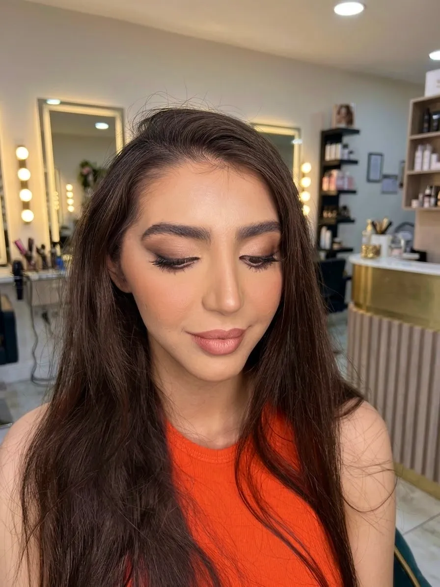 Soft brown smoky eyes with a warm nude lip and long loose hair
